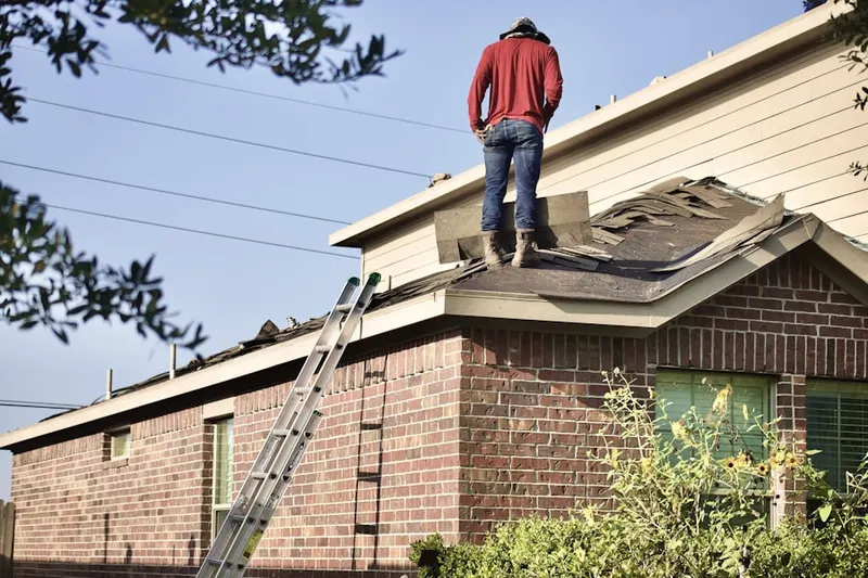 Professional roofer working on a residential roof in Cedar Crest Manor